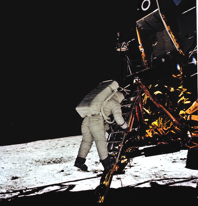APOLLO 11 ONBOARD PHOTO: ASTRONAUT ALDRIN MAKES FIRST STEP ONTO THE SURFACE OF THE MOON.